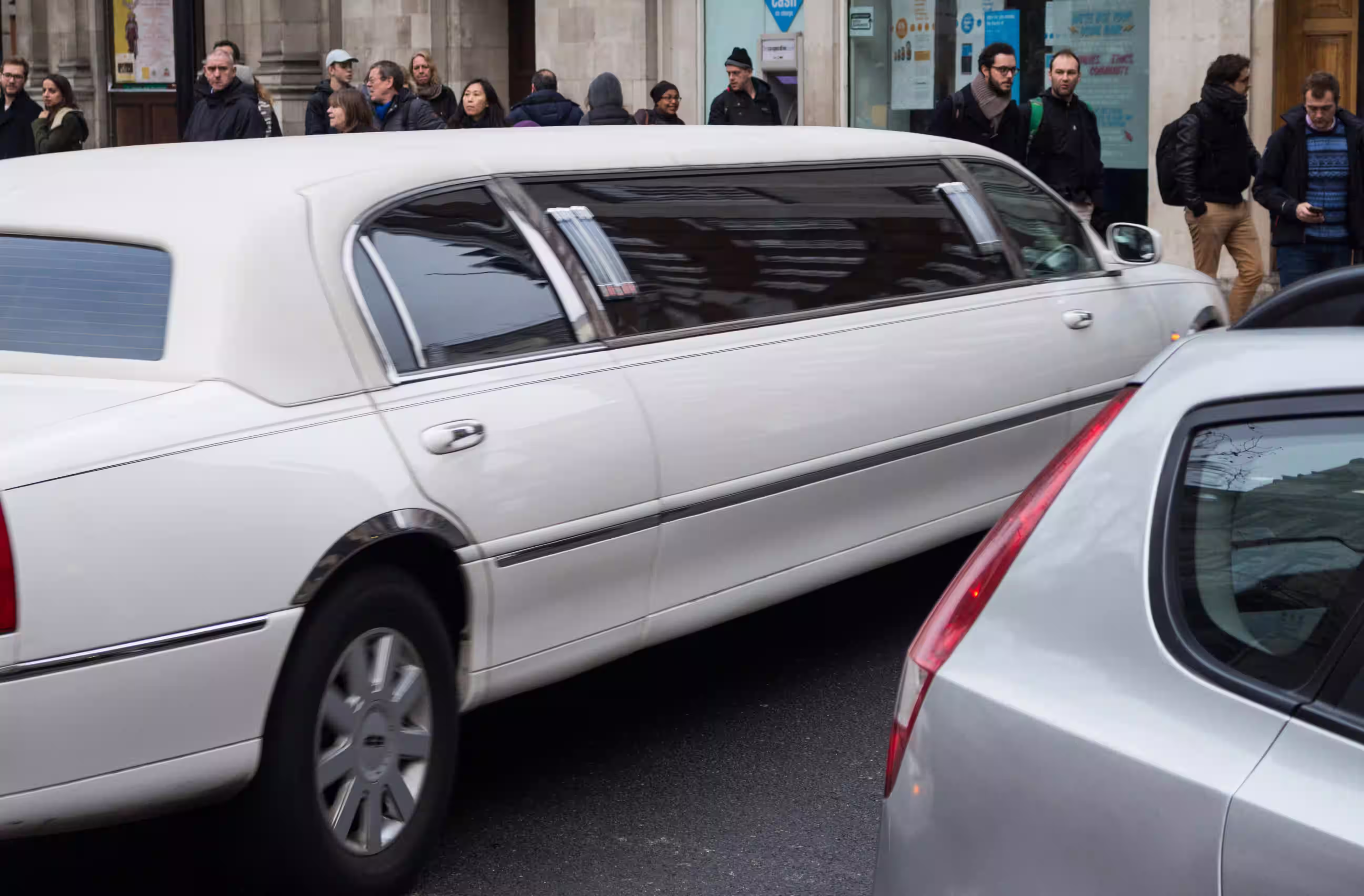 Bride and groom stepping out of a luxury vehicle